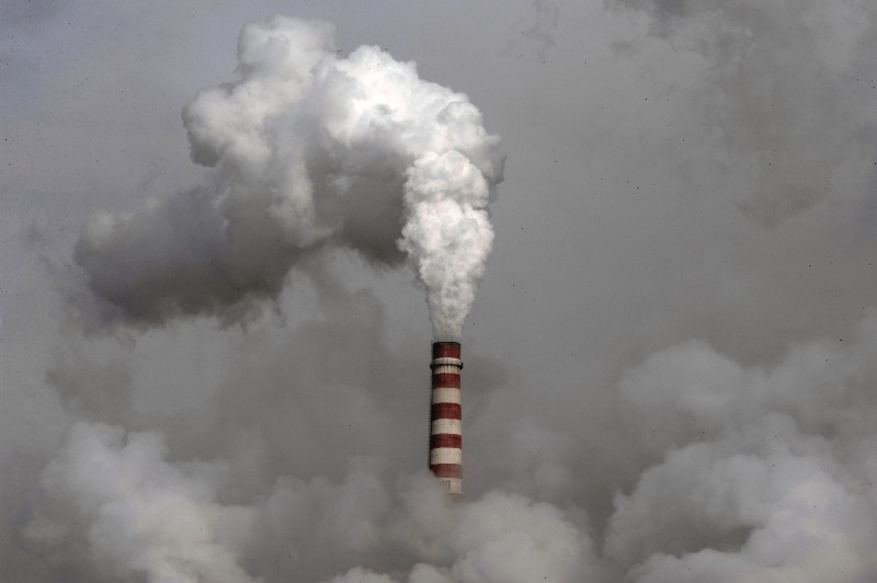 In this Dec. 3, 2009 file photo smoke billows from a chimney of the cooling towers of a coal-fired power plant in Dadong, Shanxi province, China. CREDIT: AP PHOTO/ANDY WONG, FILE