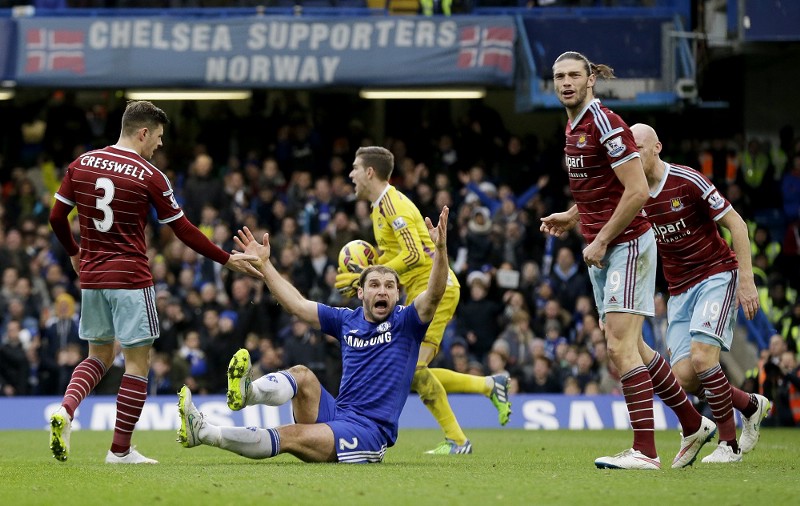 West Ham and Chelsea players during a December 2014 match. The two English clubs are the only of the Premier League’s 20 teams to commit to paying stadium and club workers a living wage. CREDIT: (AP PHOTO/MATT DUNHAM)