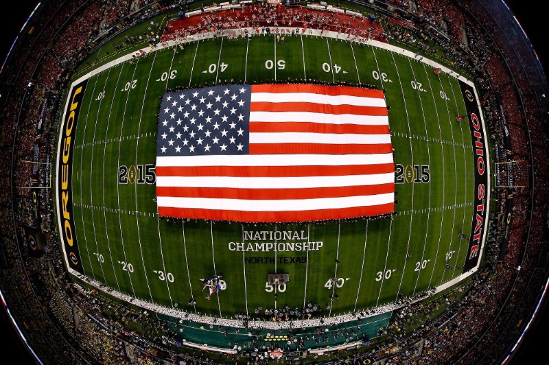An American flag fills the field before college football’s national championship game at Dallas’ AT&T Stadium, which was partially financed with tax-free government bonds. CREDIT: (AP PHOTO/TOM PENNINGTON, POOL)