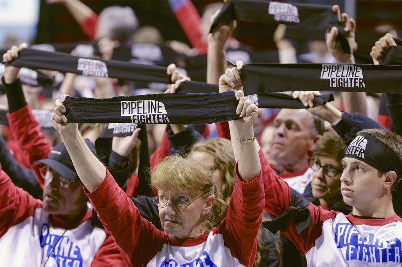Those opposing the Keystone XL pipeline hold up banners during the U.S. State Department’s sole public hearing in Grand Island, Neb., Thursday, April 18, 2013, to allow citizens to make their views known. CREDIT: AP PHOTO/NATI HARNIK