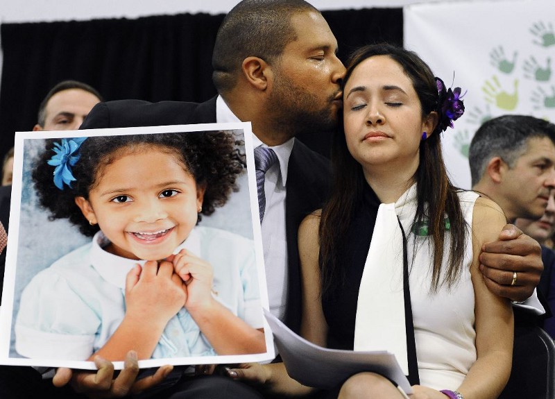 Jimmy Greene and Nelba Marquez-Greene hold a portrait of their daughter, Sandy Hook School shooting victim Ana Marquez-Greene. CREDIT: AP PHOTO/JESSICA HILL