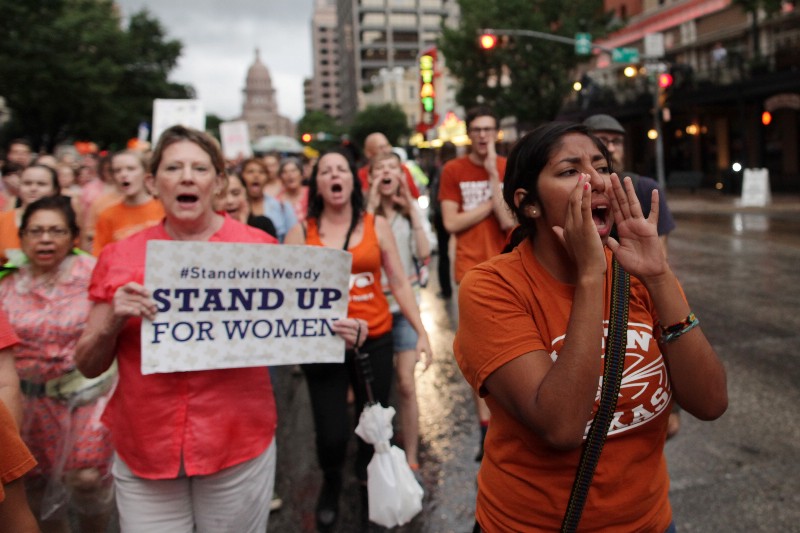 Abortion rights advocates march to protest restrictions in Texas CREDIT: AP PHOTO/TAMIR KALIFA