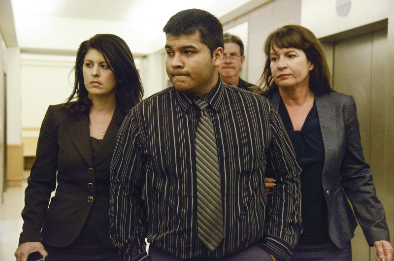 Erick Munoz, center, husband of Marlise Munoz is escorted by attorneys. CREDIT: AP PHOTO/TIM SHARP