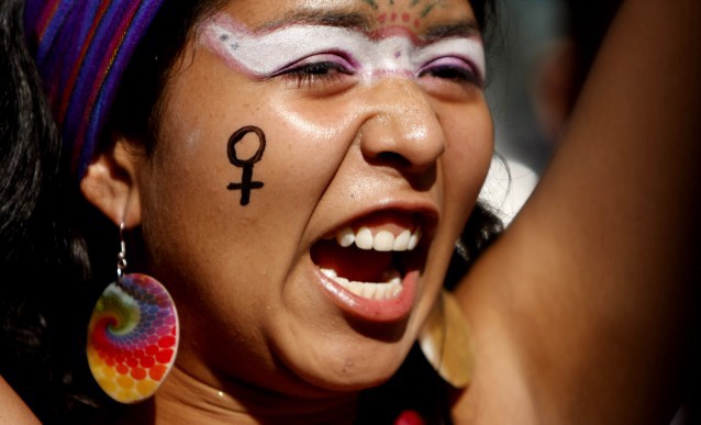A women’s rights protester shouts during a march in San Salvador CREDIT: AP Photo/Luis Romero