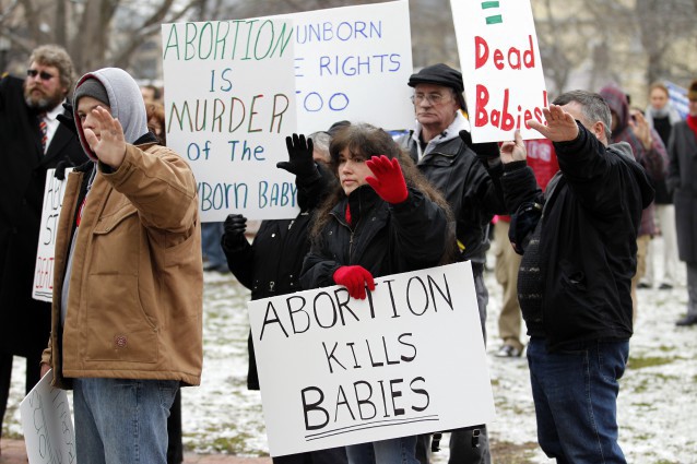 Anti-abortion supporters direct a prayer toward the White House CREDIT: AP Photo/Jose Luis Magana