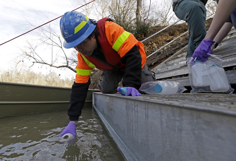 In this Feb. 5, 2014 file photo, Didi Fung, a contractor for the Environmental Protection Agency, collects water samples from the Dan River in North Carolina. CREDIT: AP PHOTO/GERRY BROOME