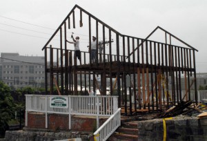 Workers disassemble the former home of Susette Kelo, in New London, CT, after it was taken by eminent domain. CREDIT: AP Photo/Jack Sauer