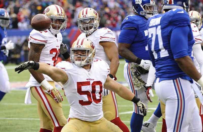 49ers linebacker Chris Borland celebrates an interception in November. CREDIT: (AP PHOTO/BILL KOSTROUN, FILE)