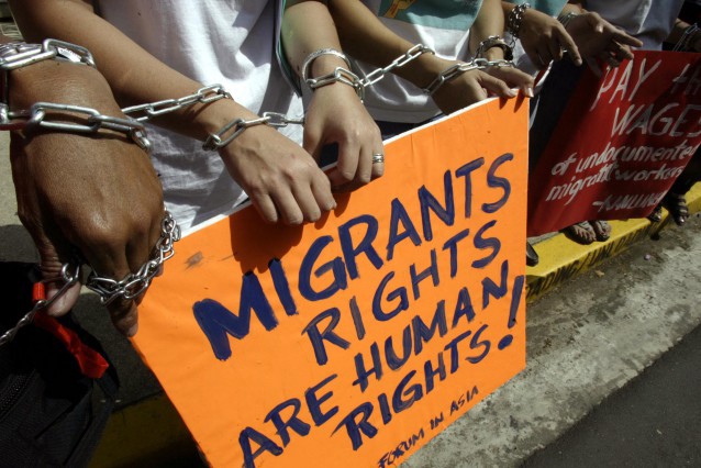 Protesters picket the Malaysian Embassy on behalf of migrant workers CREDIT: AP Photo/Bullit Marquez