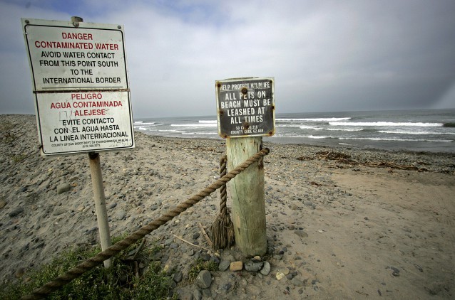 Signs warn beachgoers of contaminated water at Imperial Beach, Calif., south of San Diego. Waters at Imperial Beach have been found to contain PCBs. CREDIT: AP