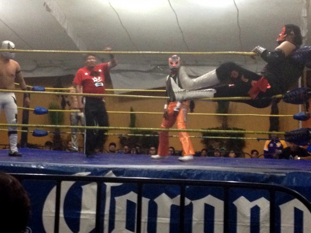 The referee admonishes a luchador for taking a front-row seat to watch the others fight. CREDIT: Scott Keyes