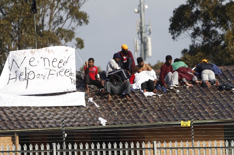 Asylum seekers hold a protest on the roof of the Villawood detention center in Sydney, Australia, in Sept. 21, 2010. The group were protesting on the roof of the detention center where they were being held Tuesday, saying they were scared of being returned to their home countries and upset over the death of a fellow detainee who was about to be deported. CREDIT: AP