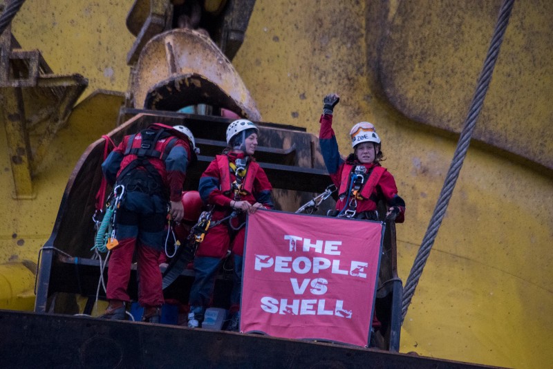Greenpeace activists hold a banner that reads ‘The People vs. Shell’ as they scaled the Polar Pioneer drill rig in the Pacific Ocean. CREDIT: VINCENZO FLORAMO / GREENPEACE