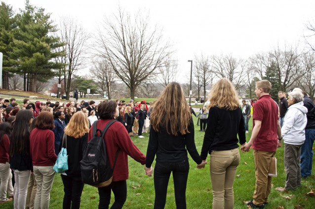 Attendees pray at Wednesday’s vigil. CREDIT: Celia Flesher