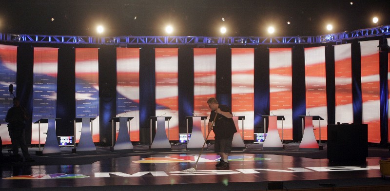 A worker mops the floor of the stage prior to the first Democratic presidential primary debate of the 2008 election hosted by the South Carolina State University in Orangeburg, SC., Thursday, April 26, 2007. CREDIT: AP PHOTO/DAVE MARTIN