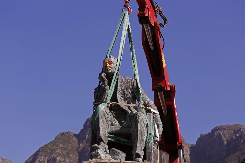 A crane prepares to remove the statue of British colonialist Cecil John Rhodes at the Cape Town University in Cape Town, South Africa, Thursday, April 9, 2015. The University of Cape Town will today remove the statue of British colonialist Cecil John Rhodes after weeks of protest by South African students, who said the statue had become a symbol of the slow racial transformation on campus. CREDIT: AP