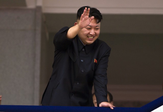 North Korean leader Kim Jong Un leans over a balcony and waves to Korean War veterans cheering below at the end of a mass military parade on Kim Il Sung Square in Pyongyang to mark the 60th anniversary of the Korean War armistice. CREDIT: AP