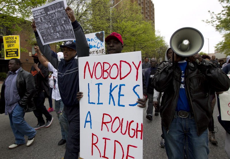 Demonstrators protest in the streets as they march for Freddie Gray to Baltimore’s City Hall, Saturday, April 25, 2015. Gray died from spinal injuries about a week after he was arrested and transported in a police van. CREDIT: AP PHOTO/JOSE LUIS MAGANA