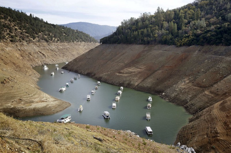 In this Thursday, Oct. 30, 2014, file photo, houseboats float in the drought-lowered waters of Oroville Lake near Oroville, Calif. CREDIT: AP PHOTO/RICH PEDRONCELLI, FILE