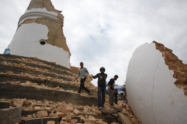 Volunteers work to remove debris at the historic Dharahara tower, a city landmark, leveled by a 7.8 magnitude earthquake that shook much of Nepal on April 25, 2015. CREDIT: AP