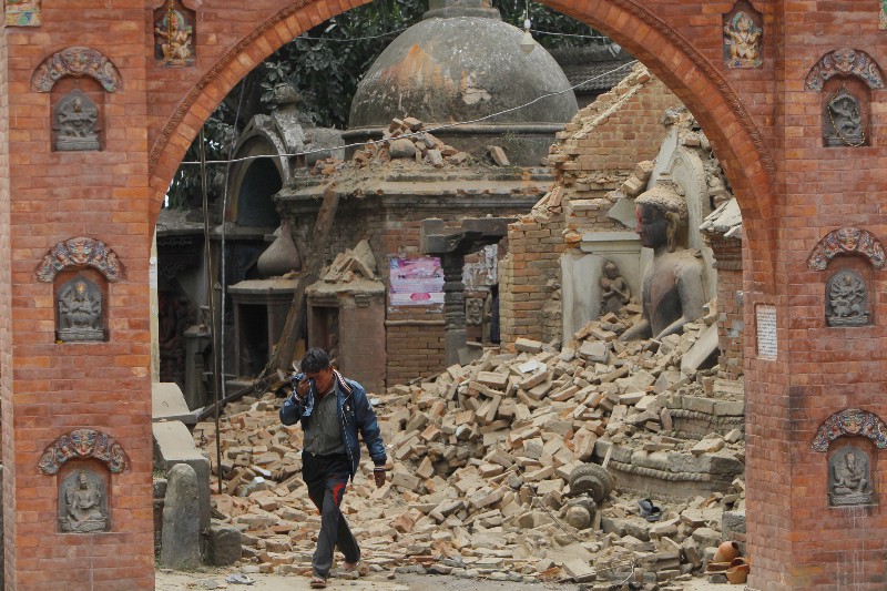 A Nepalese man cries as he walks through the earthquake debris in Bhaktapur, near Kathmandu, Nepal, Sunday, April 26, 2015. A strong magnitude 7.8 earthquake shook Nepal’s capital and the densely populated Kathmandu Valley before noon Saturday, causing extensive damage with toppled walls and collapsed buildings, officials said. CREDIT: AP