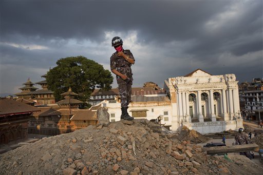 A Nepalese policeman stands atop of a rubble at Basantapur Durbar Square that was damaged in Saturday’s earthquake in Kathmandu, Nepal. CREDIT: AP