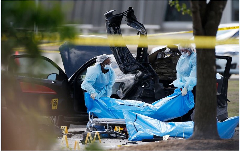 Personnel remove the bodies of two gunmen Monday, May 4, 2015, in Garland, Texas. CREDIT: AP