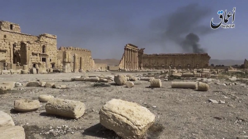 In this image made from a militant video posted on YouTube on May 26, 2015, which has been verified and is consistent with other AP reporting, smoke rises behind archaeological ruins in Palmyra, Syria. CREDIT: AP