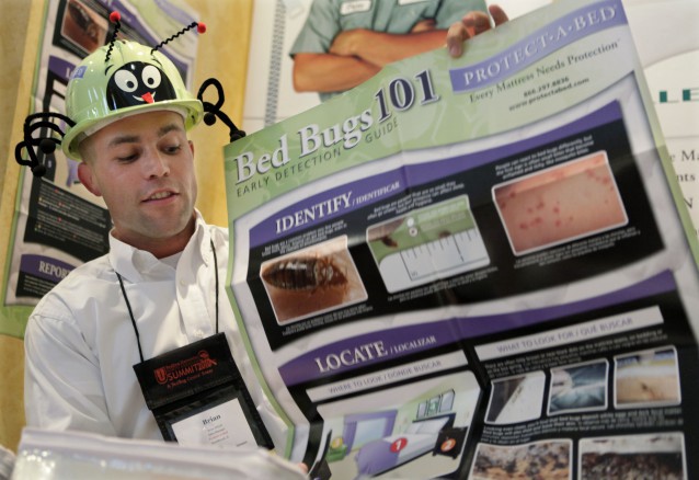 A sales manager for Protect A Bed displays literature during the first North American Bed Bug Summit, held in Illinois in 2010 CREDIT: AP Photo/M. Spencer Green