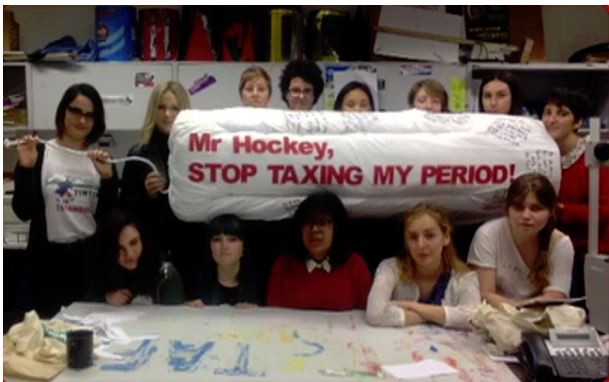 Subeta Vimalarajah (center, in red) with her giant tampon CREDIT: Screenshot via ABC.NET.AU