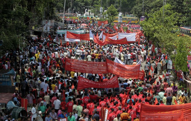 Bangladeshi garment workers and activists gather on a road during a May Day rally, in Dhaka, Bangladesh, Friday, May 1, 2015. CREDIT: AP