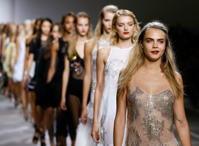 Model Cara Delevingne leads out the models at the end of the show by designer Topshop Unique during the Spring/Summer 2015 show at London Fashion Week. CREDIT: AP Photo/Kirsty Wigglesworth
