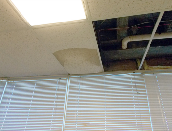 Tiles were removed from a ceiling at a BIE school because it continued to leak. CREDIT: GAO