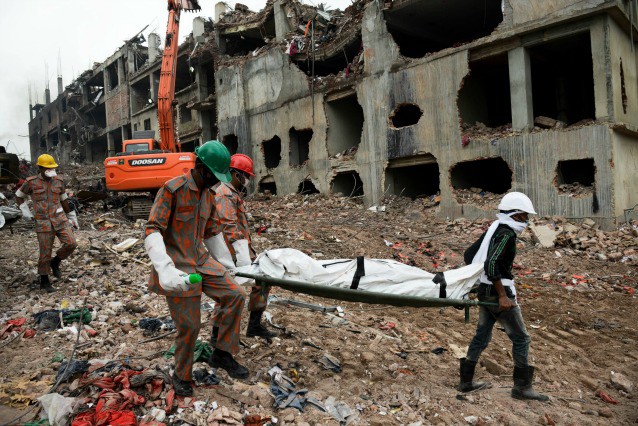 Rescuers carry a body retrieved from the rubble of the eight-story Rana Plaza building that collapsed in Savar, near Dhaka, Thursday, May 9, 2013. CREDIT: AP Photo/Ismail Ferdous