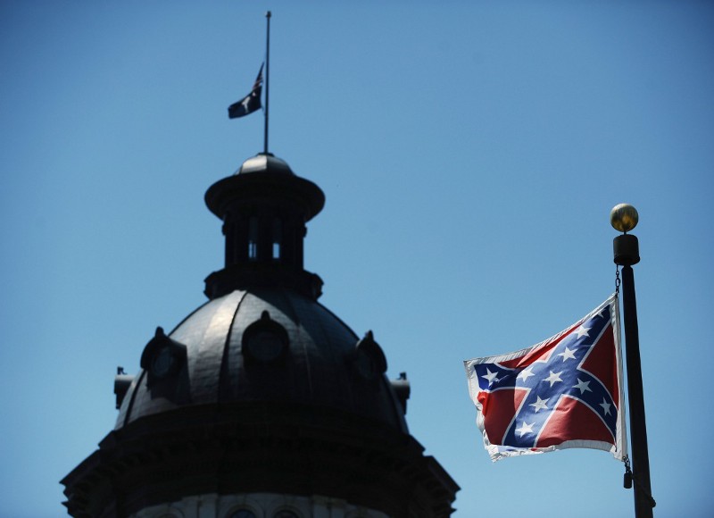 The Confederate flag flies near the South Carolina Statehouse, Friday, June 19, 2015, in Columbia, S.C. CREDIT: AP./RAINIER EHRHARDT
