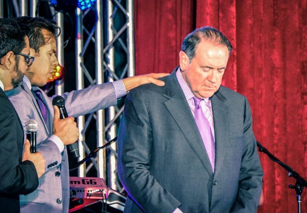 Rodriguez prays over former Gov. Mike Huckabee at the NHCLC conference. CREDIT: Jack Jenkins/ThinkProgress