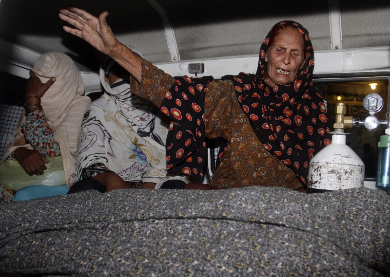 A family member of a pregnant woman who was stoned to death by a mob wails over her body in an ambulance at a local hospital in Lahore, Pakistan. The father of Farzana Parveen and four other men have been charged with killing her after she married against the family’s wishes and their trial was set to begin on Monday, police said. CREDIT: AP