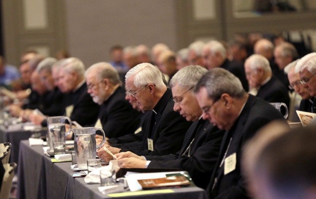 Participants pray at the start of the morning general session at the United States Conference of Catholic Bishops in New Orleans, Wednesday, June 11, 2014. CREDIT: AP Photo/Gerald Herbert