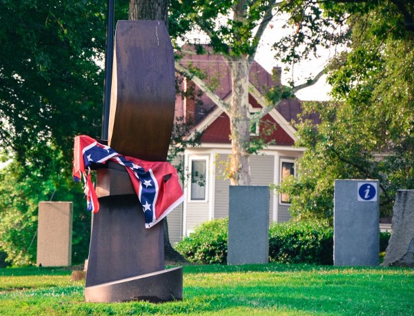 A Confederate flag is tied around the neck of a statue on the museum grounds this week, directly next to where the other Confederate flag flies. The purpose of the protest was unclear. CREDIT: Jack Jenkins/ThinkProgress