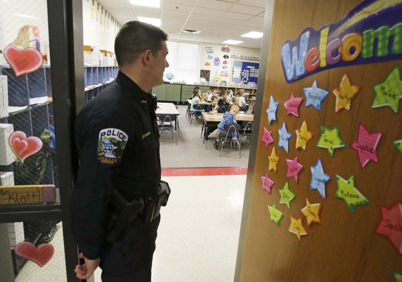 Police presence in schools, zero tolerance policies and biases in favor of white students put students of color at a disadvantage when it comes to school discipline. CREDIT: AP PHOTO/JIM MONE