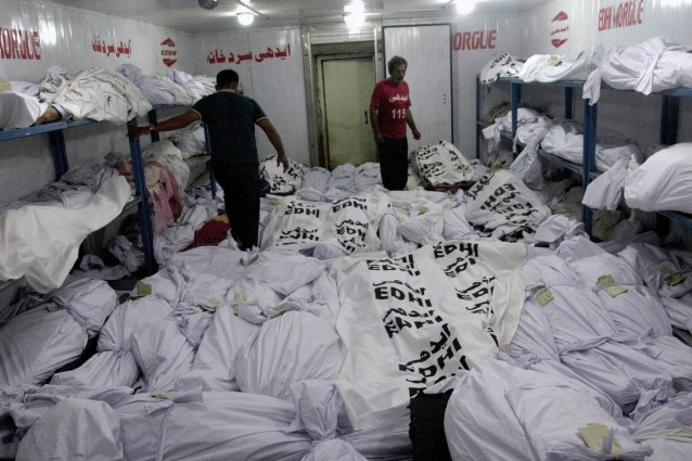Volunteers arrange the lifeless bodies of heatstroke victims at a morgue of a charity group, in Karachi, Pakistan. CREDIT: AP