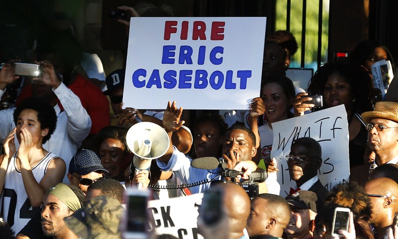 Demonstrators gather near a community pool Monday, June 8, 2015, during a protest in response to an incident at the pool involving McKinney police officers in McKinney, Texas. CREDIT: AP PHOTO/RON JENKINS
