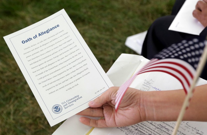The Oath of Allegiance is held by Sau Hou Chang of Macau at a naturalization ceremony at the Benjamin Harrison Presidential Site in Indianapolis, Thursday, July 3, 2014. Judge Sarah Evans Barker naturalized 101 new citizens at the ceremony. The ceremony was part of an annual celebration of Independence Day by U.S. Citizenship and Immigration Services. CREDIT: AP PHOTO/MICHAEL CONROY