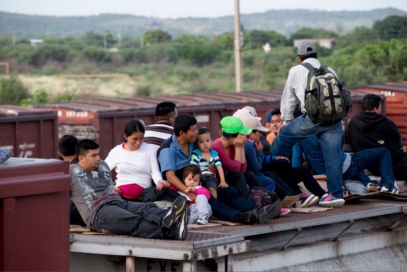 Central American migrants ride a freight train during their journey toward the U.S.-Mexico border in Ixtepec, Mexico, Saturday, July 12, 2014. The number of unaccompanied minors detained on the U.S. border has more than tripled since 2011. Children are also widely believed to be crossing with their parents in rising numbers. CREDIT: AP PHOTO/EDUARDO VERDUGO