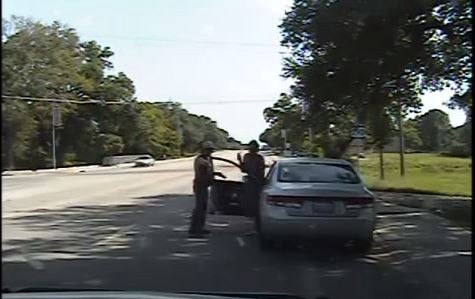 Screenshot of State Trooper Brian Encinia pointing gun at Sandra Bland CREDIT: YOUTUBE