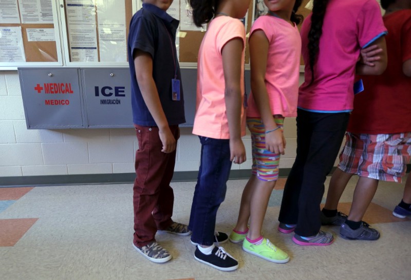 In this Sept. 10, 2014 file photo, detained immigrant children line up in the cafeteria at the Karnes County Residential Center, a temporary home for immigrant women and children detained at the border, in Karnes City, Texas. CREDIT: AP PHOTO/ERIC GAY