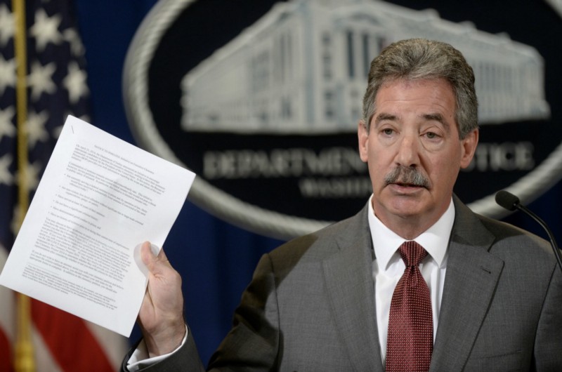 Deputy Attorney General James Cole holds up a list of guidelines during a news conference at the Justice Department in Washington. CREDIT: AP PHOTO/SUSAN WALSH