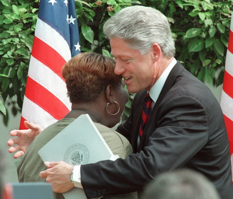 President Clinton hugs a former welfare recipient in 1996 after signing a sweeping overhaul of public assistance program rules. CREDIT: AP