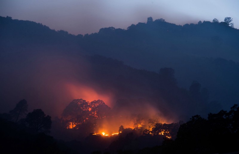 A wildfire burns in Napa, California. CREDIT: AP PHOTO/NOAH BERGER