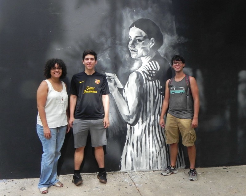 Student activists at the University of Puerto Rico stand by a portrait of Antonia Martínez — a student killed by police in 1970 while protesting the Vietnam War. CREDIT: ALICE OLLSTEIN